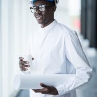 imgi_22_young-afro-american-engineer-with-blue-prints-front-panoramic-windows-office_231208-2242